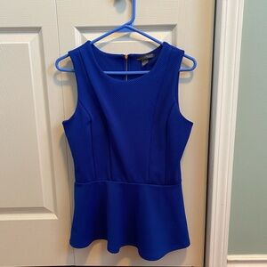 Royal blue top with zipper back and flared waist. Women’s Size small